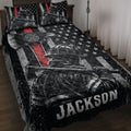 Firefighter quilt blanket displayed on a bed with patriotic flag artwork, helmets, stars, and bold red accents