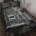 Trucker quilt blanket displayed on a bed with black and gray semi truck artwork, stars, and American-inspired details