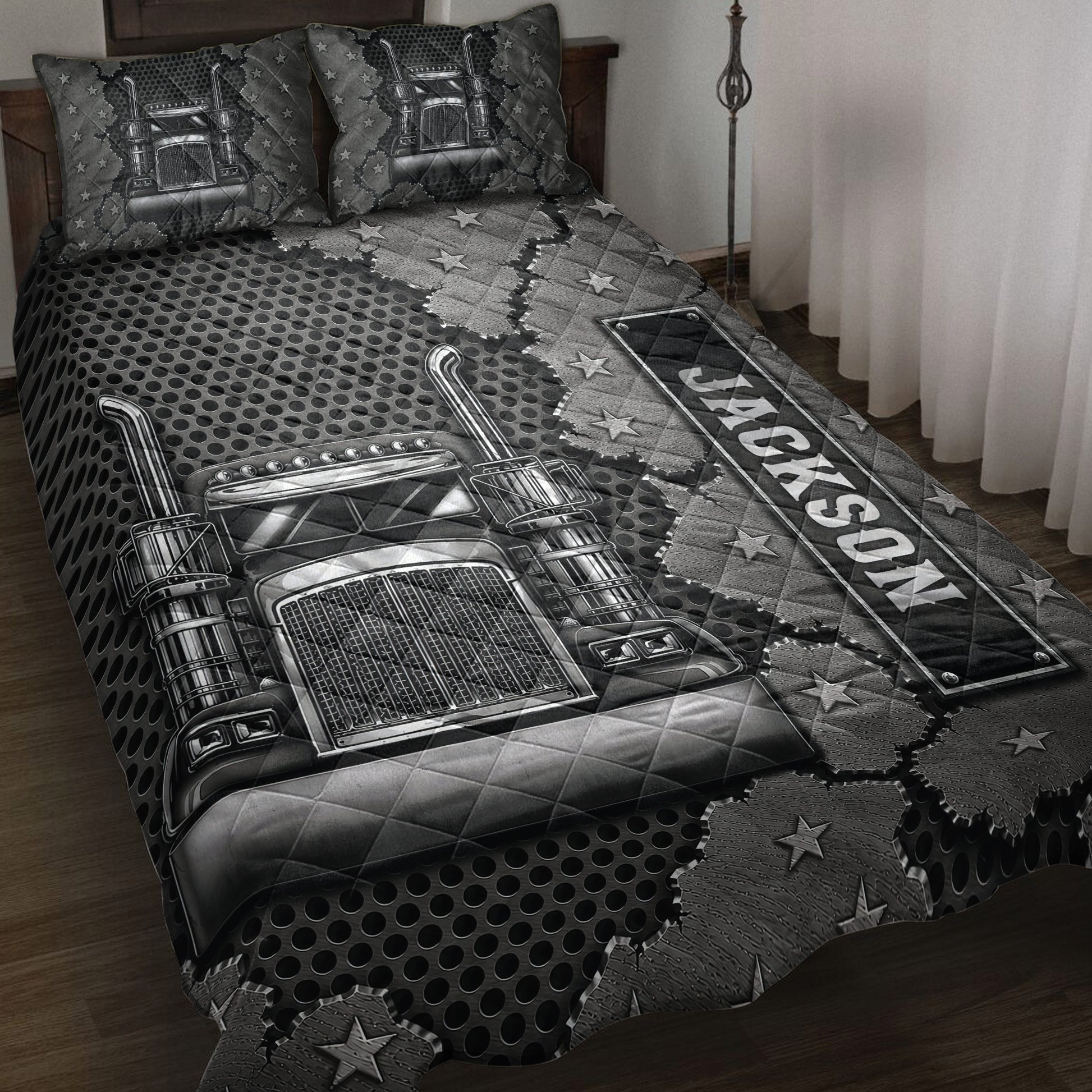 Trucker quilt blanket displayed on a bed with black and gray semi truck artwork, stars, and American-inspired details