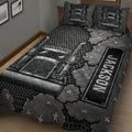 Black and gray trucker quilt spread across a bed with detailed semi truck graphics and star accents