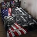 Firefighter quilt blanket displayed on a bed with patriotic stars, stripes, helmets, and rescue gear artwork