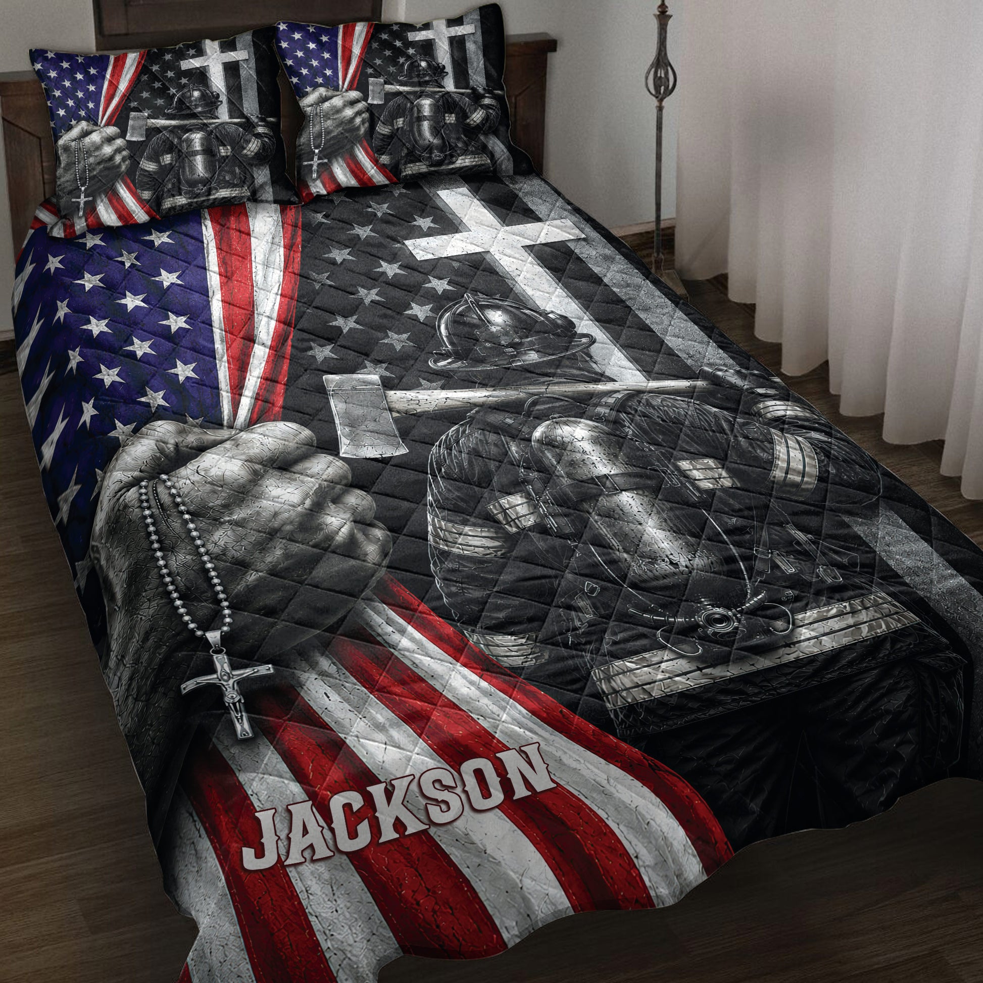 Firefighter quilt blanket displayed on a bed with patriotic stars, stripes, helmets, and rescue gear artwork