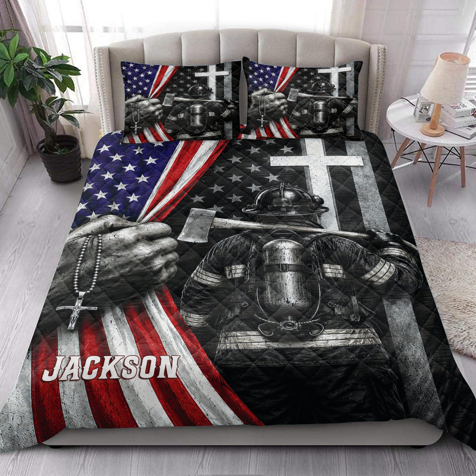 Firefighter quilt blanket styled on a bedroom bed with bold red, white, blue, and black artwork