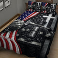 Close bedroom view of firefighter quilt bedding with helmet, protective gear, axe, and patriotic flag design