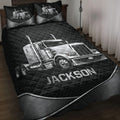 Black trucker quilt blanket set displayed on a bed with silver semi-truck artwork and matching pillow designs