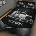 Black quilt blanket with detailed silver semi-truck artwork and matching truck-themed pillow designs
