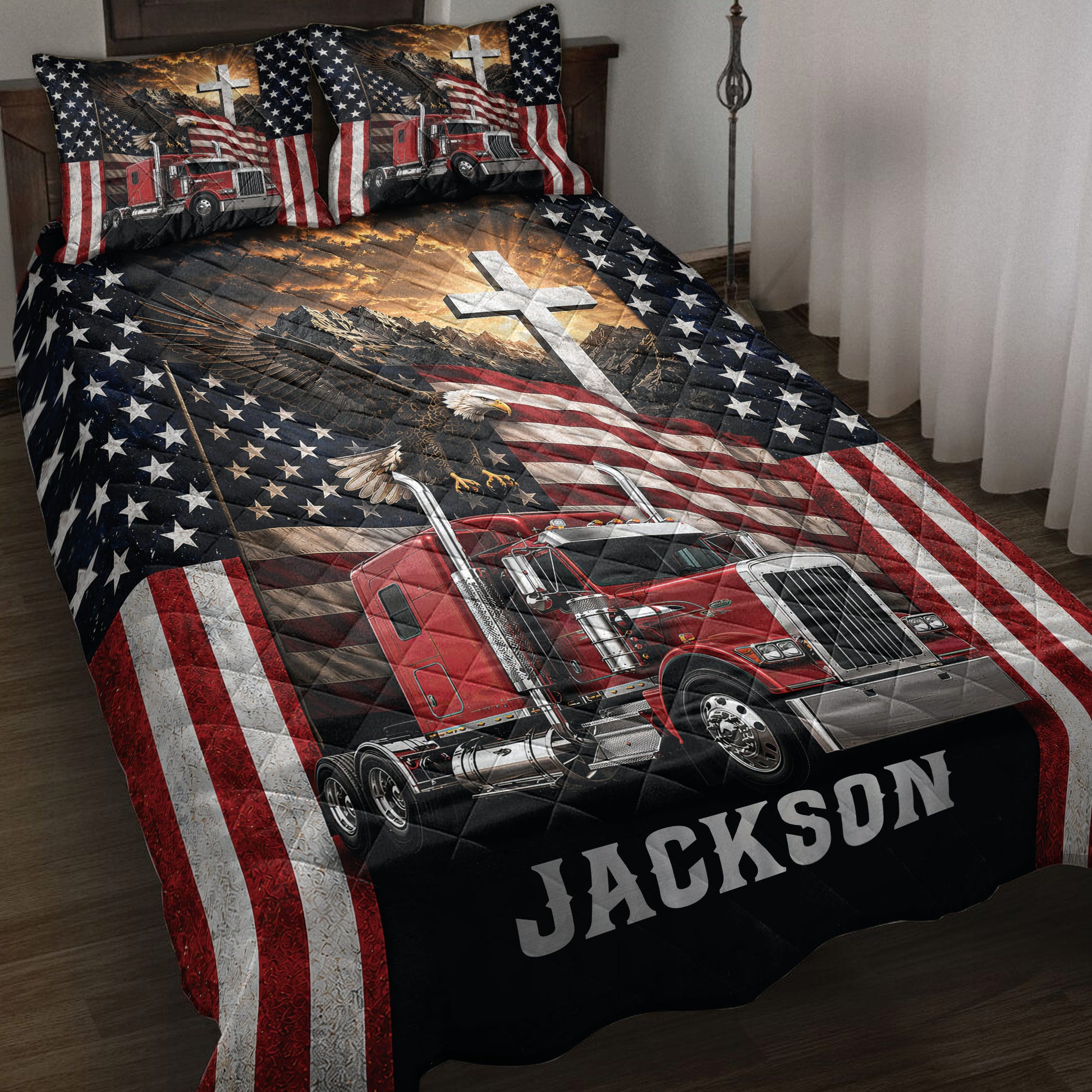 Trucker quilt blanket displayed on a bed with red semi truck, eagle, American flag, stars, mountains, and cross artwork