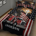 Close bedroom view of a trucker quilt blanket featuring a red semi truck, eagle, American flag, stars, and mountain scene
