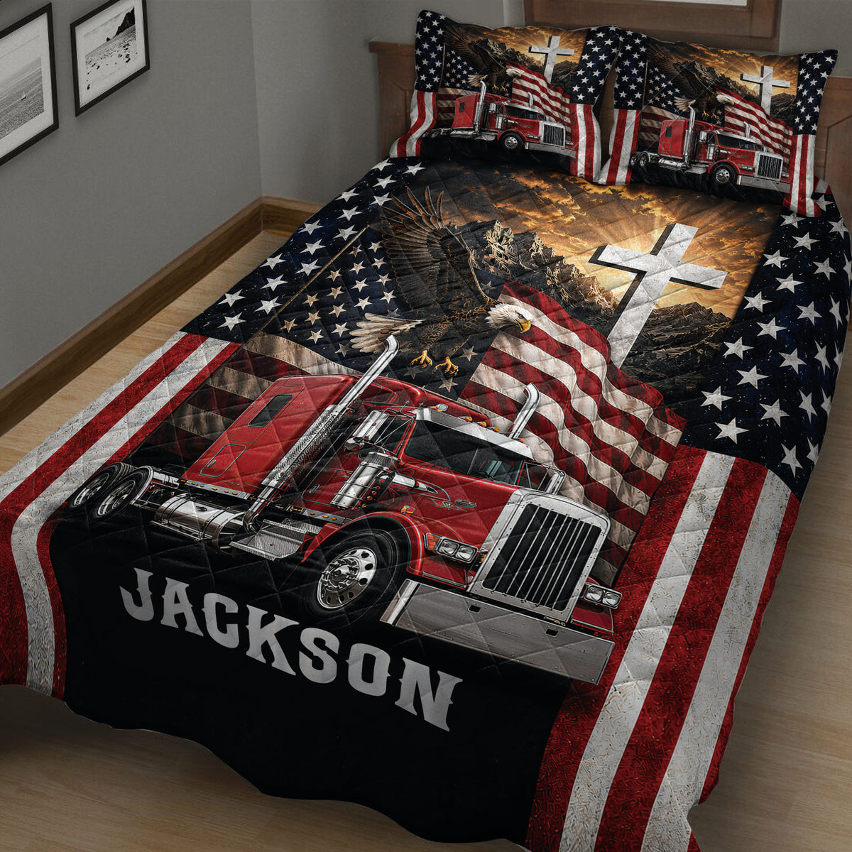 Close bedroom view of a trucker quilt blanket featuring a red semi truck, eagle, American flag, stars, and mountain scene