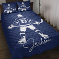 Navy hockey quilt blanket styled on a bed with skater artwork and matching hockey-themed pillow designs