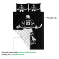 Black hockey quilt blanket showing the printed front and white quilted reverse side