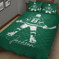 Green hockey quilt blanket displayed on a bed with skater artwork and matching hockey-themed pillows
