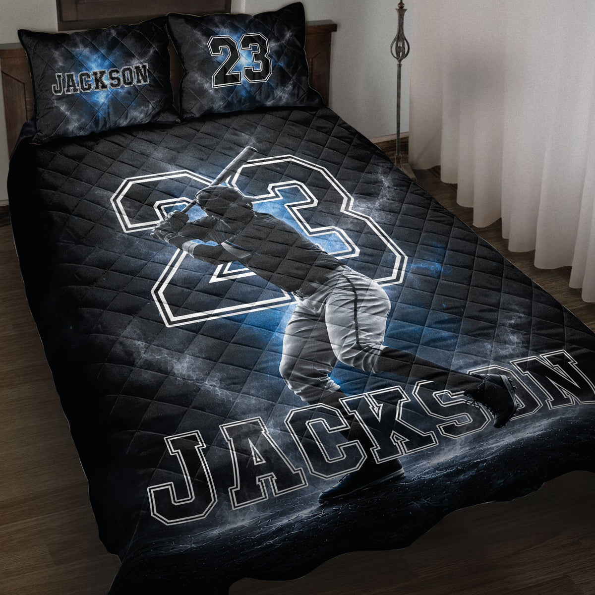 Black and blue baseball quilt blanket displayed on a bed with batter artwork and coordinated pillow designs