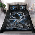 Baseball quilt blanket styled on a bedroom bed with dramatic batter artwork and blue highlights