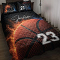 Basketball quilt blanket on a bedroom bed with fiery basketball artwork, hoop graphics, and bold sports styling