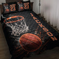 Black and orange basketball quilt bedding set displayed on a bed with hoop, net, and basketball artwork