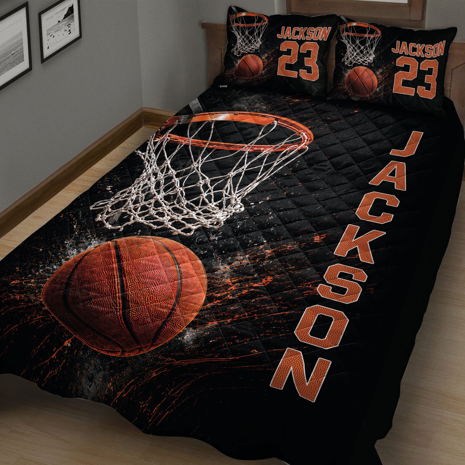 Close bedroom view of a basketball quilt blanket featuring a hoop, net, and orange basketball design