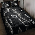 Black football quilt blanket displayed on a bed with dramatic player artwork and bold athletic graphics