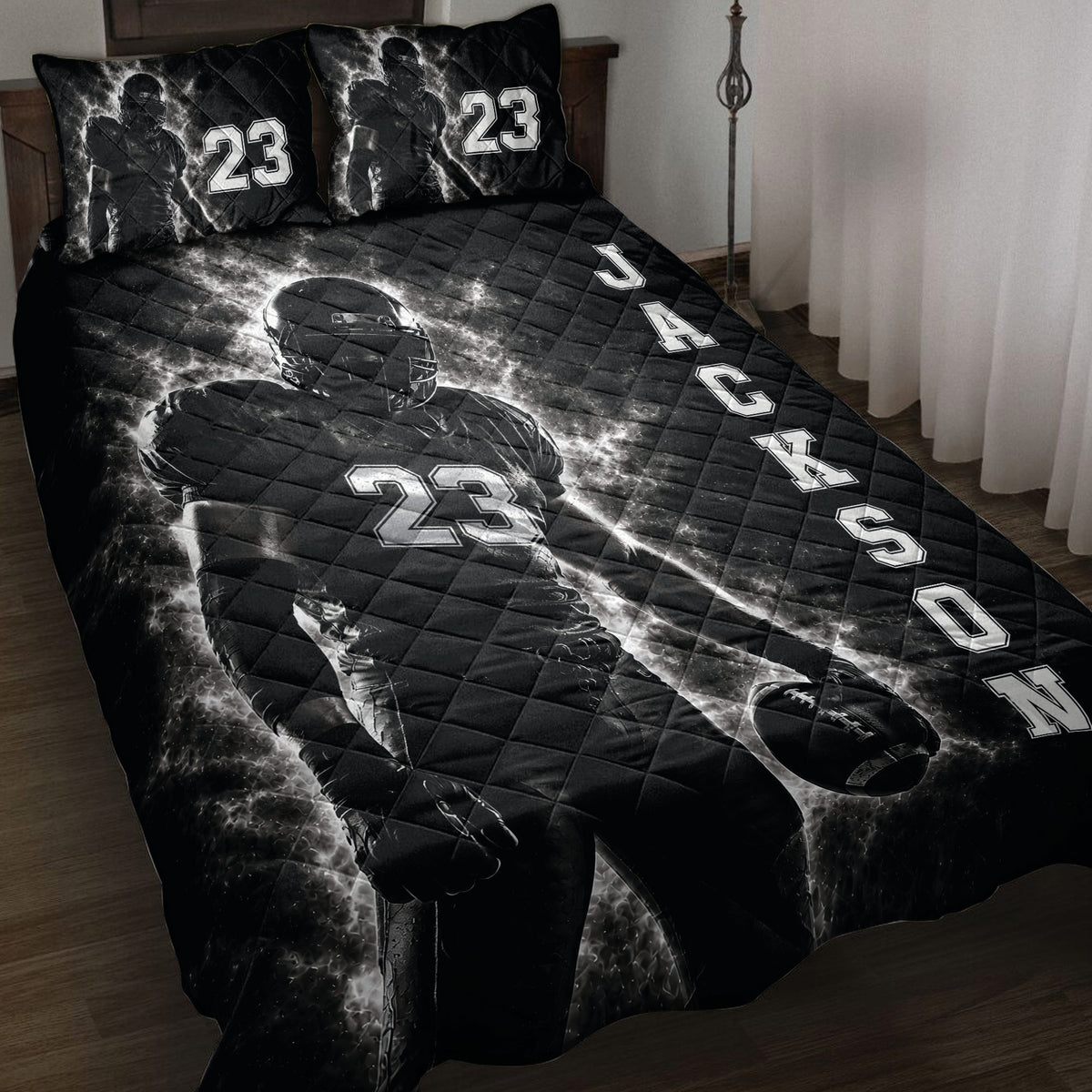 Black football quilt blanket displayed on a bed with dramatic player artwork and bold athletic graphics