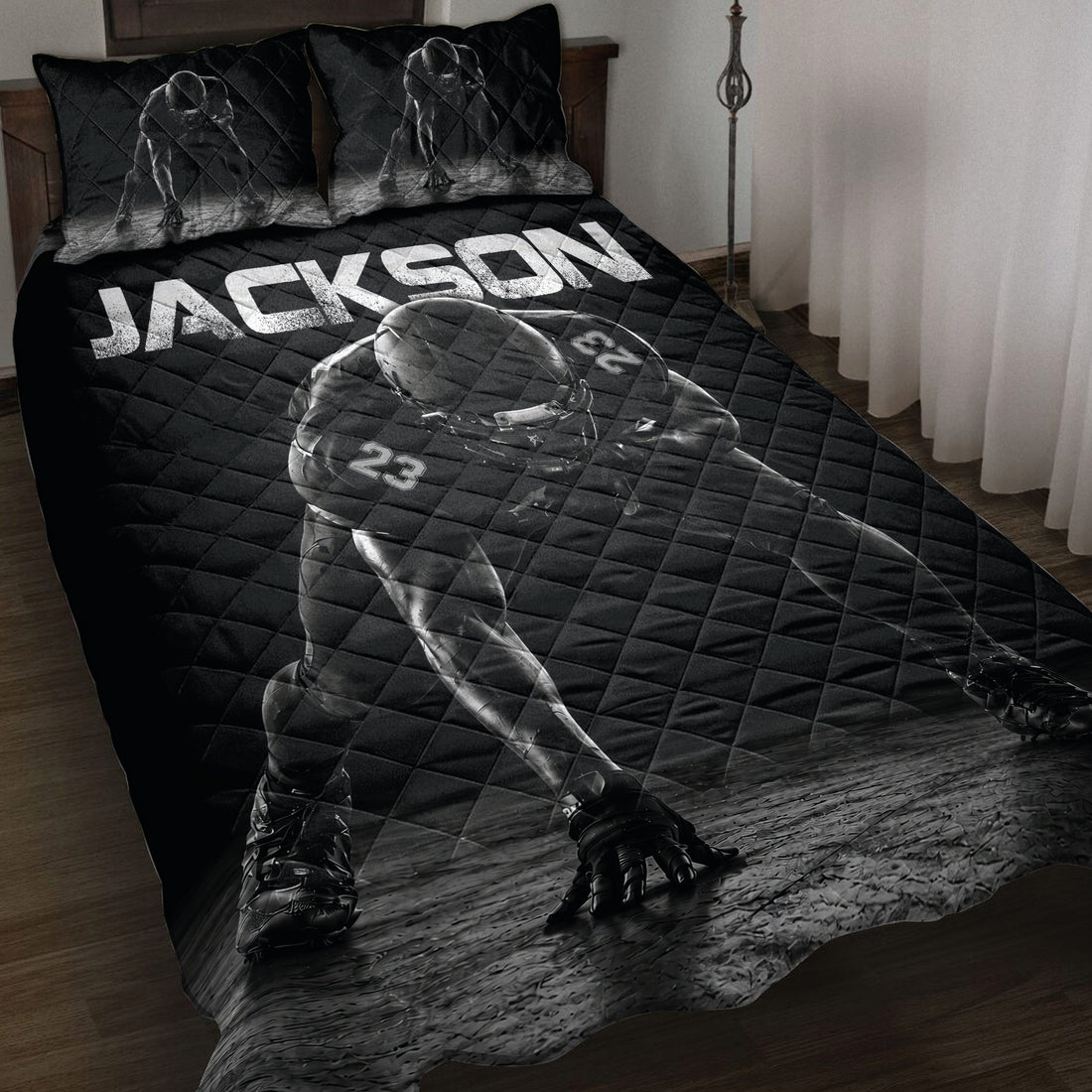 Black football quilt blanket on a bed with dramatic helmeted player artwork
