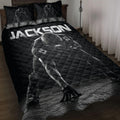 Black football quilt blanket on a bed with dramatic helmeted player artwork