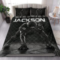 Black football quilt styled in a bedroom with bold player artwork