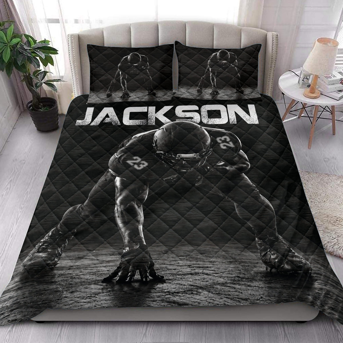 Black football quilt styled in a bedroom with bold player artwork