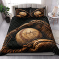 Baseball quilt blanket styled in a bright bedroom with baseball and glove artwork across the bed