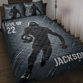 Football quilt blanket displayed on a bed with dark blue sports artwork and helmeted player design
