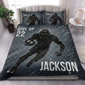 Football quilt bedding set styled in a bedroom with dark blue player and football artwork