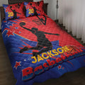 Red and blue basketball quilt blanket displayed on a bed with player silhouettes, hoops, stars, and bold sports artwork