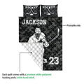 Hockey quilt shown with skating player artwork, dark camouflage print, white backing, and quilted construction