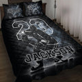 Black hockey quilt blanket displayed on a bed with an ice hockey player, skates, puck, and dramatic rink artwork