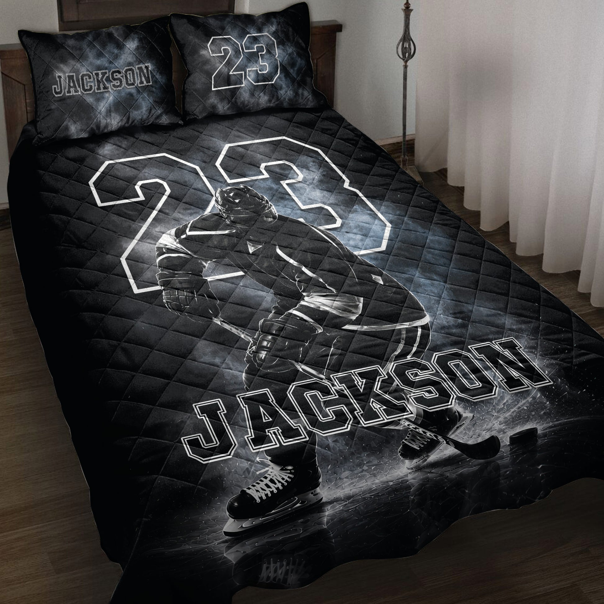 Black hockey quilt blanket displayed on a bed with an ice hockey player, skates, puck, and dramatic rink artwork