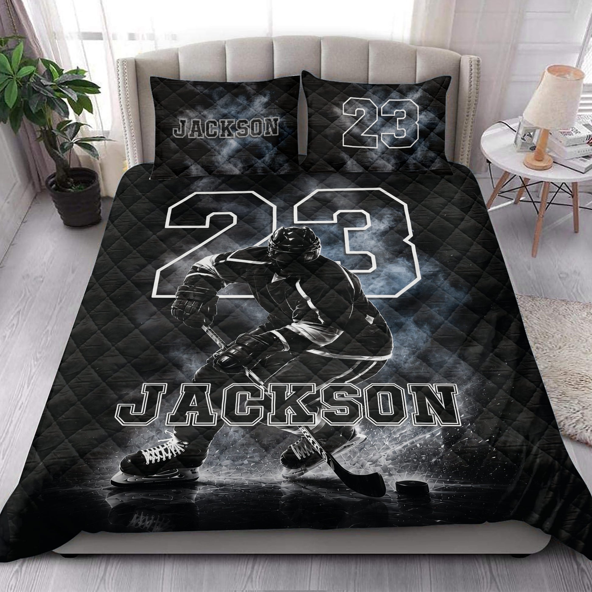 Hockey quilt blanket styled on a bedroom bed with ice hockey player artwork and bold monochrome graphics