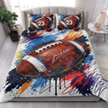 American football quilt blanket styled on a bedroom bed with colorful sports artwork and matching design pillows