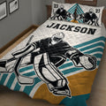 Close bedroom view of hockey goalie quilt bedding with bold black, teal, white, and gold artwork