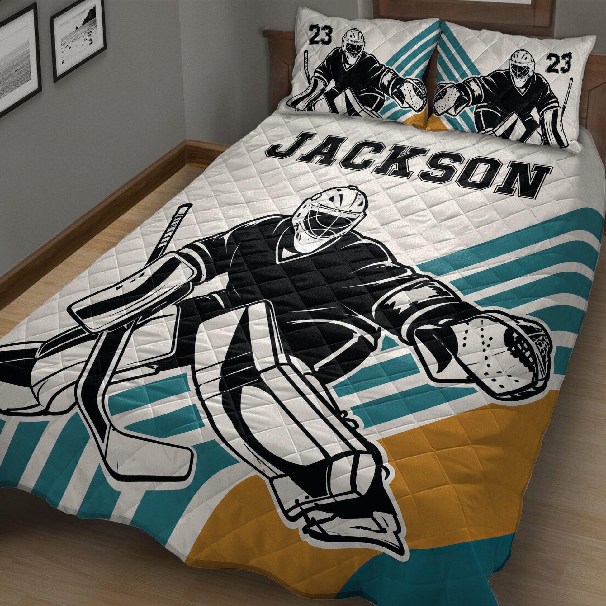 Close bedroom view of hockey goalie quilt bedding with bold black, teal, white, and gold artwork