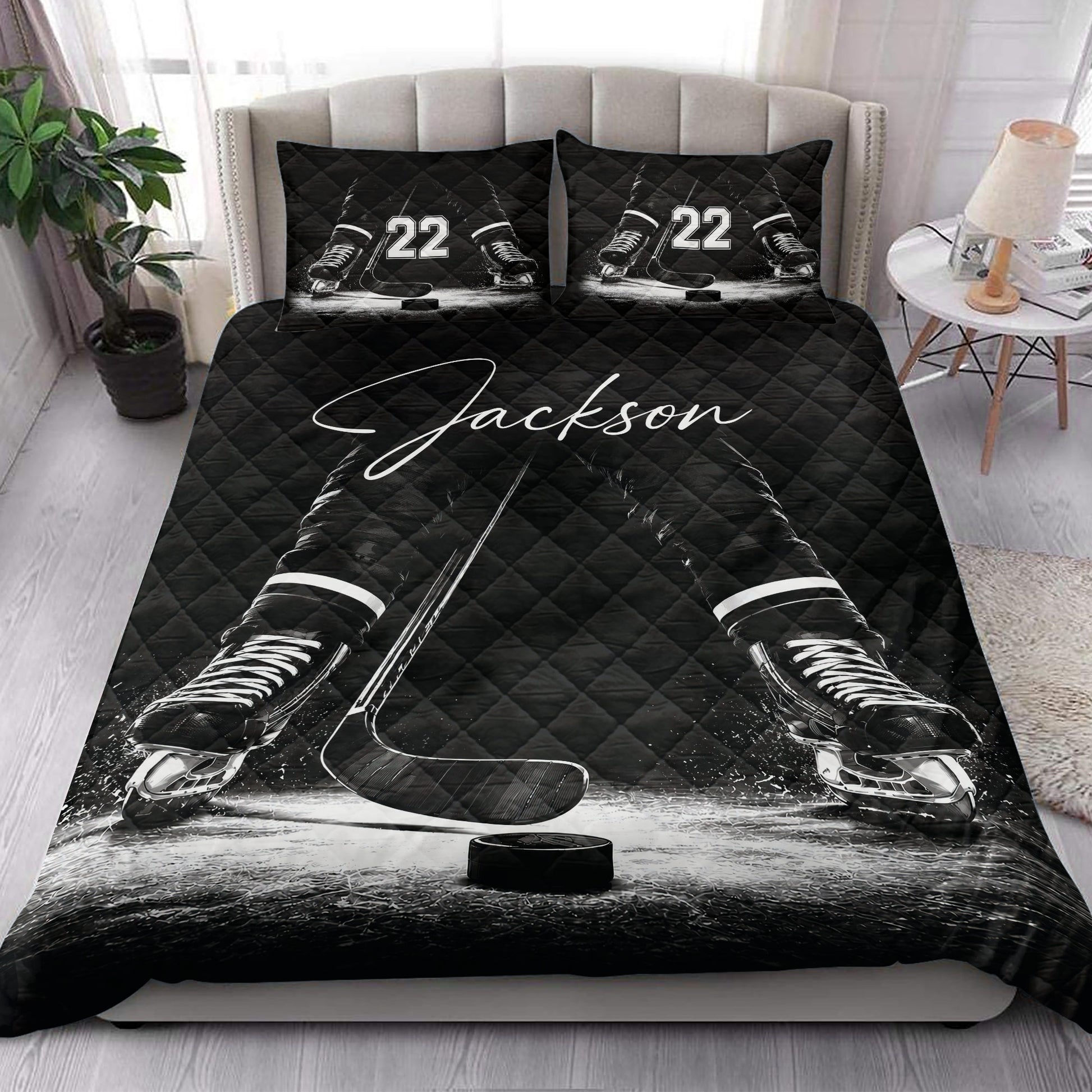 Hockey quilt blanket styled on a bedroom bed with black ice hockey skates and stick design