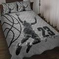 Basketball quilt blanket displayed on a bed with grayscale player artwork and oversized basketball graphics