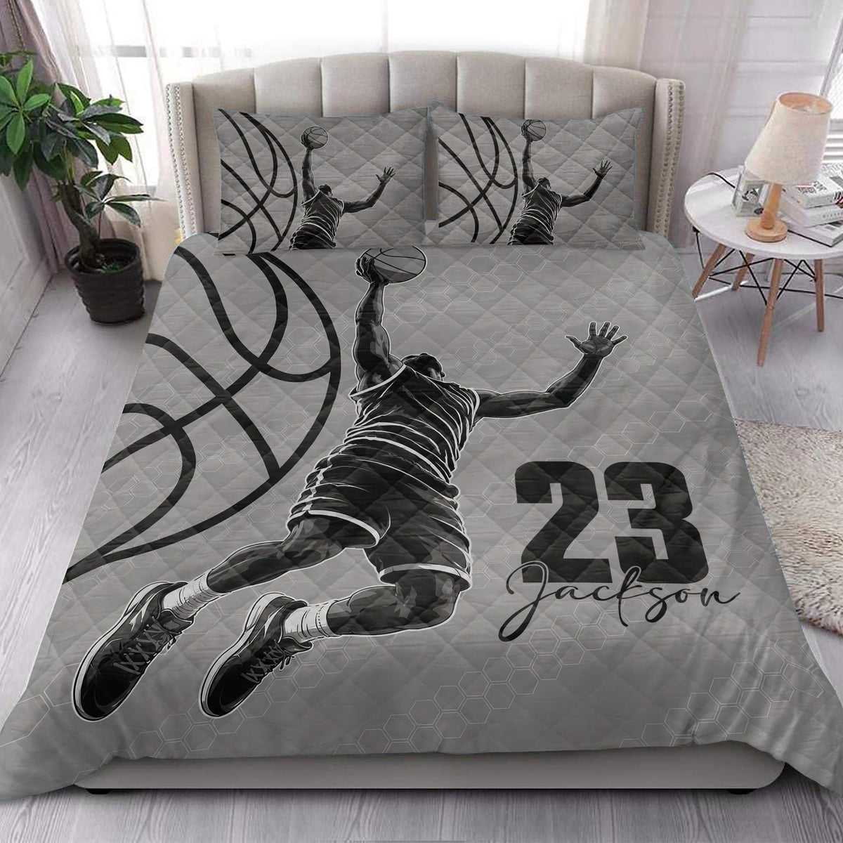 Basketball quilt bedding styled in a bright bedroom with grayscale player artwork and bold basketball graphics