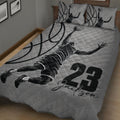 Close bedroom view of a basketball quilt blanket featuring a dynamic player silhouette and basketball pattern