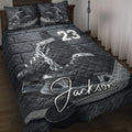 Black-and-gray hockey quilt blanket displayed on a bed with ice skates, pucks, and bold sports artwork