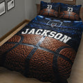 Angled bedroom view of a basketball quilt blanket featuring basketball texture, hoop artwork, and arena lighting