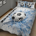 Close bedroom view of a soccer quilt blanket featuring a large ball and blue goal-net artwork