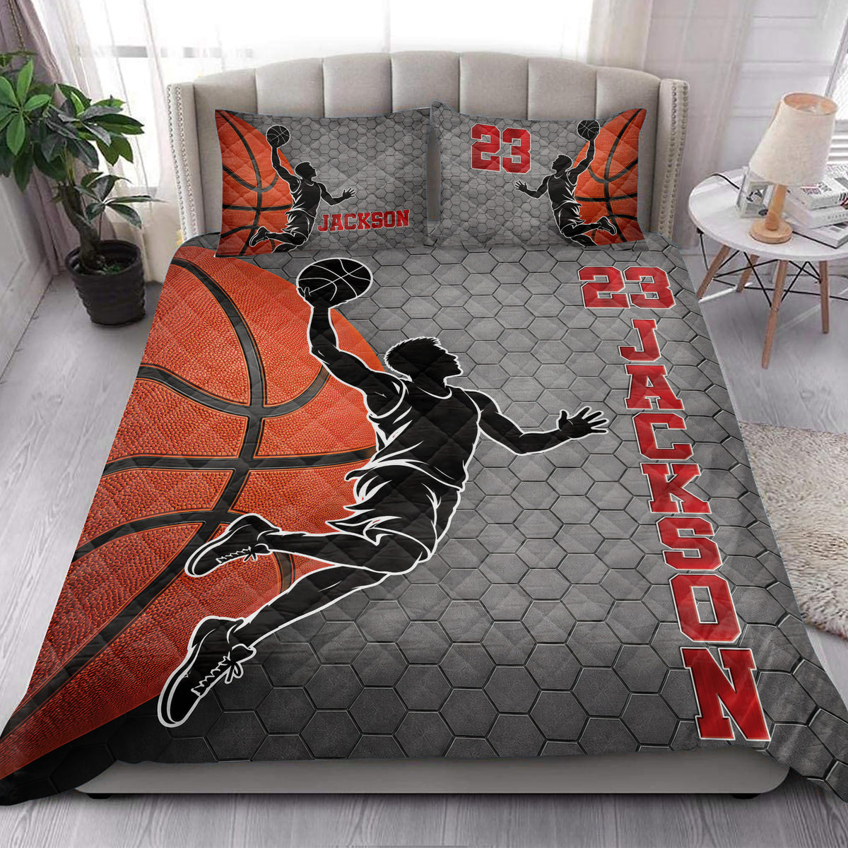 Basketball quilt blanket styled on a bed with orange basketball graphics and dynamic player silhouettes