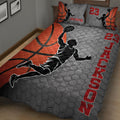 Close view of basketball quilt bedding with a jumping player silhouette, gray hexagon pattern, and red accents