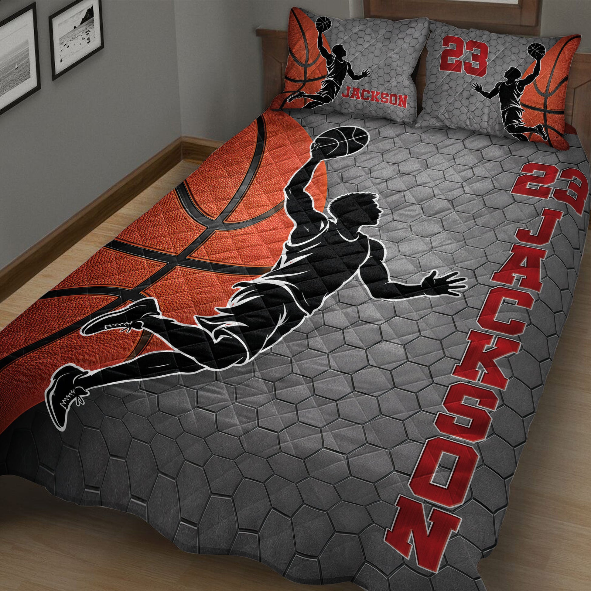 Close view of basketball quilt bedding with a jumping player silhouette, gray hexagon pattern, and red accents