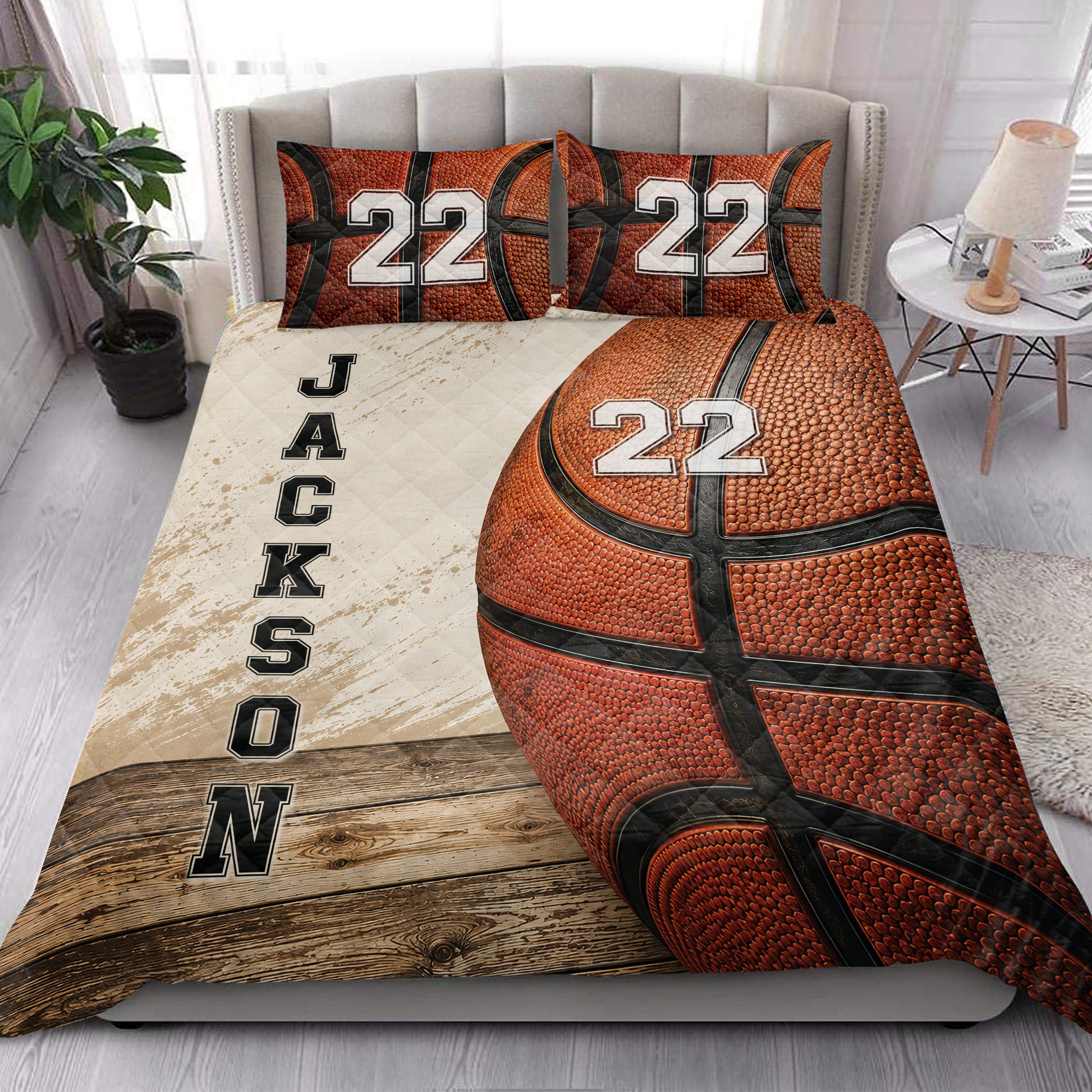 Basketball quilt bedding styled in a bright bedroom with bold orange basketball artwork