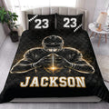Black football quilt blanket styled on a bedroom bed with bold player artwork and sports-themed pillows